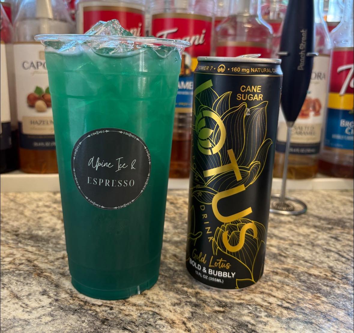 Green Italian soda with Alpine Ice & Espresso branding