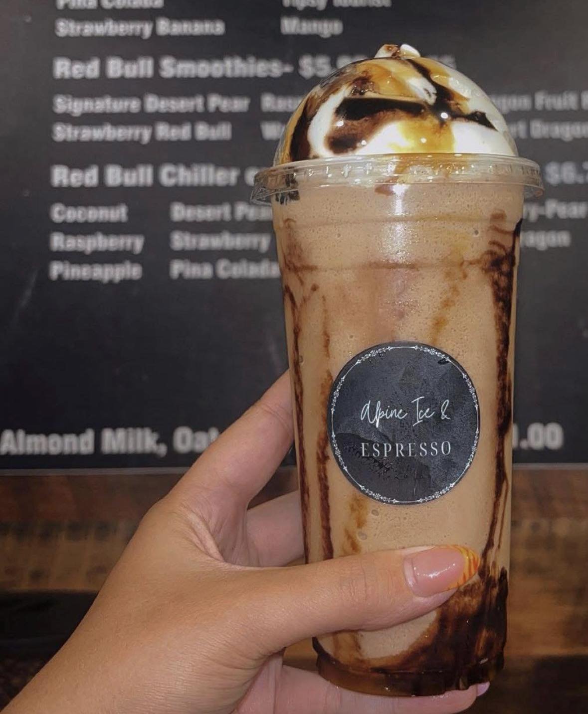 Iced coffee with whipped cream and chocolate drizzle